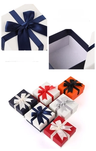 Close-up of luxury jewelry gift boxes with silk ribbon bows in various elegant colors