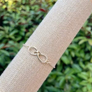 Detail of 18K gold plated infinity heart bracelet featuring pavé set cubic zirconia
