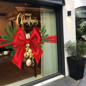 Festive Christmas window stickers with red bows, green pine, and Merry Christmas text