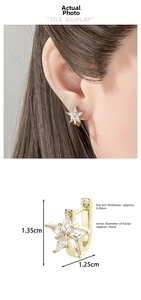 Detailed close-up and model wearing a gold star ear cuff with sparkling kite zircon stones