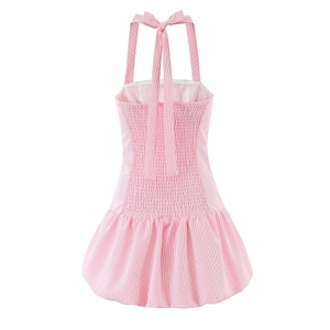 Detail of pink and white striped halter dress featuring elastic smocked back and bow tie