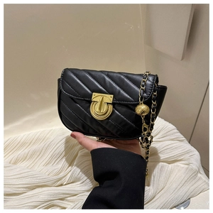Detail of black PU leather crossbody bag with V-quilt pattern and gold ball chain strap