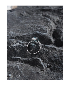 Macro detail of S925 silver ring featuring a blue rectangular stone and lava texture