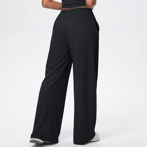 Rear view of black high-waisted wide-leg pants showing draped fabric and elastic waistband