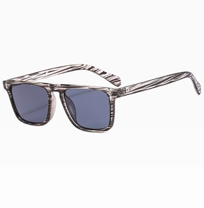 Side view of square vintage sunglasses with grey wood grain texture frame and dark lenses