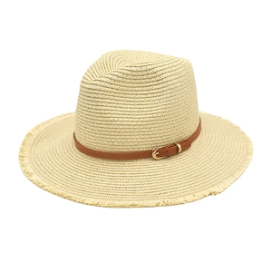 Panama straw hat in beige with frayed edges and brown leather band with gold buckle