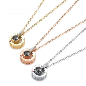 Detailed view of necklaces in gold, rose gold and silver with Roman numeral engravings