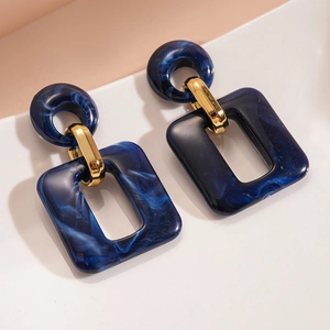 Blue marble acrylic geometric rectangle earrings with gold-tone accents on white base