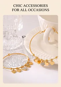 Detailed view of 18k gold plated bracelets with crystal-encrusted heart charms