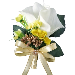 Elegant white calla lily boutonniere with golden berries and champagne ribbon bow
