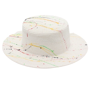 Macro shot of colorful paint splatter on a white wide-brim boater straw hat texture