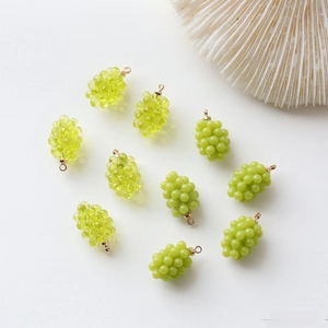 Detailed view of grape-shaped resin charms in green and translucent tones for DIY jewelry