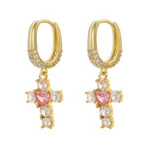 Detail of gold oval hoop earrings with pink heart zircon and sparkling crystal cross