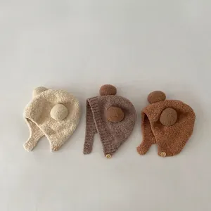 Winter plush baby ear protection hats with pom-poms in cream, brown, and caramel