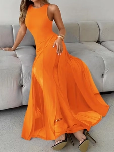 Detail of elegant orange sleeveless maxi dress featuring a high side slit and silky fabric