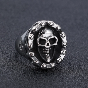Macro shot of gothic skull ring detail with chain pattern and vintage silver finish