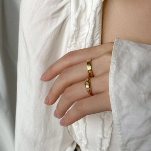 Detail of celestial gold rings with star moon engravings and zircon stone inlay