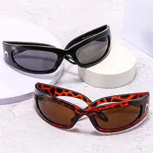 Futuristic Y2K wrap sunglasses in black and tortoiseshell with silver crescent accents