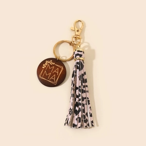 Close-up of a pink leopard print tassel keychain with a carved MAMA wood charm