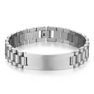 Macro detail of silver stainless steel link bracelet with engravable rectangular plaque