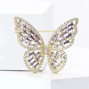 Detail of luxury gold butterfly brooch with purple and clear zircon stones in macro view