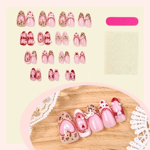 Pink and red handmade press-on nails with leopard print, bows and pearl accents