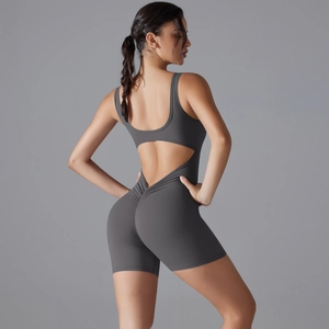 Detail of cross-back yoga bodysuit featuring V-waist design and ruched butt lifting detail