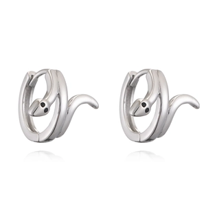 Minimalist silver snake hoop earrings with black stone eyes on a reflective white surface