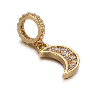 Detailed view of a gold-plated moon charm pendant with sparkling cubic zirconia inlay