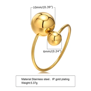 Detailed view of 10mm and 6mm gold spheres on an adjustable stainless steel ring