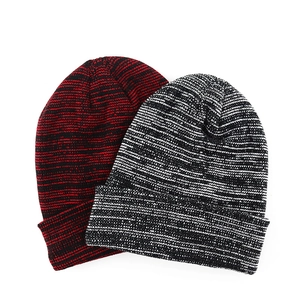 Close-up of knit texture on red and white mixed yarn beanies with folded cuffs