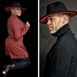 Detail of two-tone wide brim fedora hat featuring black exterior and red interior finish
