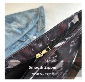 Macro shot of smooth gold metal zipper and skull floral print on the nylon bucket bag