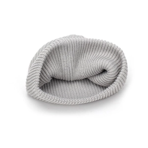 A close-up detail shot of a soft grey knitted slouchy beanie with ribbed texture