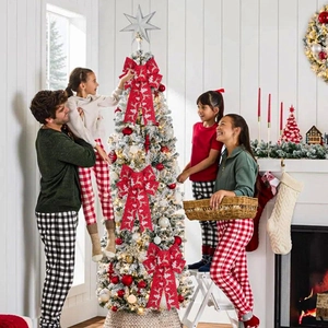 Red linen Christmas bows with reindeer and snowflake patterns on a festive tree