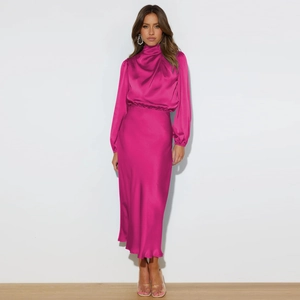 Elegant fuchsia satin halter neck dress with lantern sleeves and draped floor-length skirt