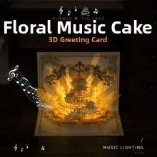 Detailed view of 3D pop-up Christmas card with glowing music cake design and warm lights