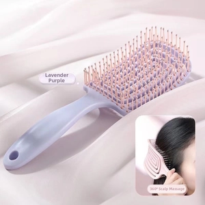 Macro detail of ergonomic taro purple massage hairbrush with flexible hollow-out back