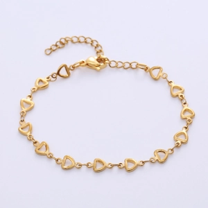 Detailed macro view of gold heart-shaped link bracelet with lobster clasp and extension
