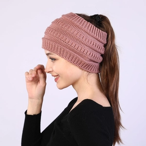 Pink chunky knit headband detail showing the ponytail hole and texture for winter