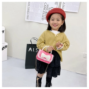 Pink tweed crossbody bag for girls featuring pearl handle and large bow detail
