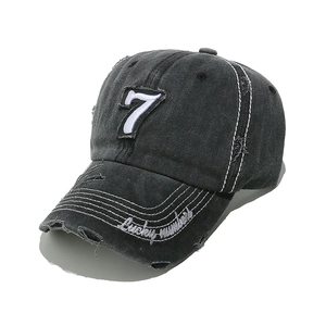 Close-up of distressed grey baseball cap with number 7 patch and Lucky numbers embroidery
