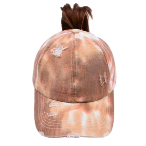 Detail of distressed tie-dye ponytail baseball cap with a hole for high messy buns