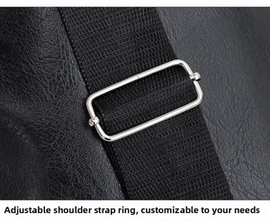 Detail view of adjustable nylon shoulder strap and silver metal buckle on black leather bag