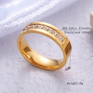6mm gold stainless steel ring featuring inlaid AAA cubic zirconia stones on a knit backdrop