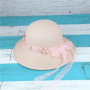 Close-up of pink woven straw sun hat featuring lace flowers, pearls and a mesh bow detail
