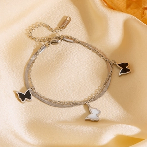 Detail of double-layer stainless steel bracelet with butterfly charms and lobster clasp