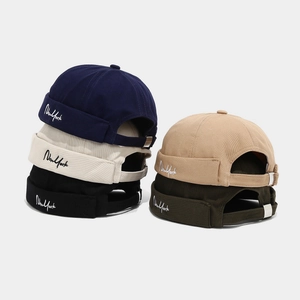 Detail showing high-quality twill cotton texture and New York embroidery on brimless caps