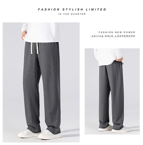 Detail view of dark grey straight-leg casual pants with drawstring waist and soft texture