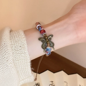 Vintage ceramic beaded bracelet with brass butterfly charm on braided cord for women